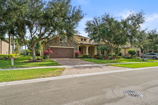 10765 Pisa Rd, Wellington, FL 33414 - view of front of property featuring a garage, decorative driveway, a front yard, and stone siding