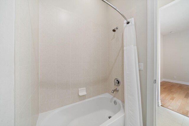 10765 Pisa Rd, Wellington, FL 33414 - bathroom featuring shower / tub combo with curtain and wood finished floors