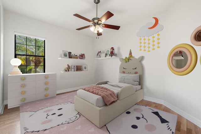 10765 Pisa Rd, Wellington, FL 33414 - bedroom featuring a ceiling fan, baseboards, and wood finished floors