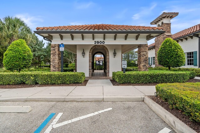 10765 Pisa Rd, Wellington, FL 33414 - exterior space with stucco siding, a tile roof, and uncovered parking