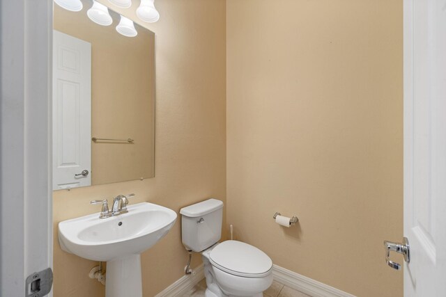10765 Pisa Rd, Wellington, FL 33414 - half bath with a sink, toilet, and baseboards