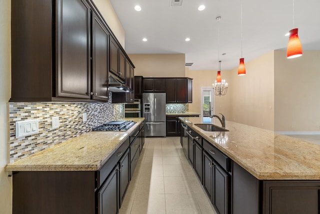 10765 Pisa Rd, Wellington, FL 33414 - kitchen with appliances with stainless steel finishes, an inviting chandelier, a sink, backsplash, and under cabinet range hood