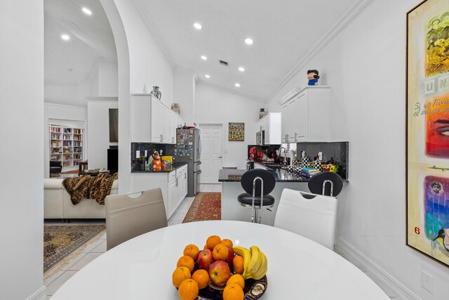 10056 Lexington Cir N, Boynton Beach, FL 33436 - kitchen with ornamental molding, decorative backsplash, recessed lighting, white cabinetry, and light tile patterned floors