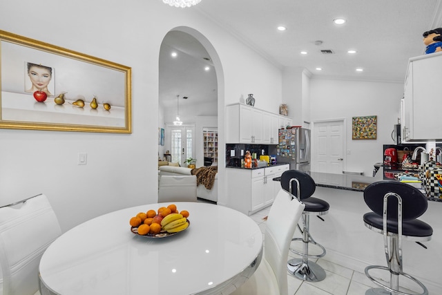 10056 Lexington Cir N, Boynton Beach, FL 33436 - dining area featuring visible vents, arched walkways, light tile patterned floors, ornamental molding, and recessed lighting