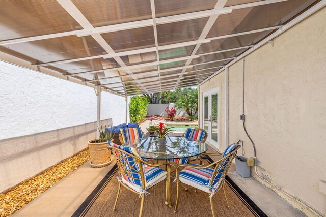 10056 Lexington Cir N, Boynton Beach, FL 33436 - view of patio / terrace featuring french doors, fence, and outdoor dining area