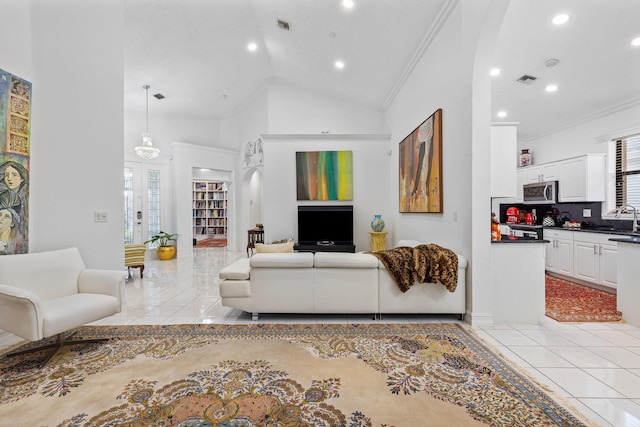 10056 Lexington Cir N, Boynton Beach, FL 33436 - living room with arched walkways, recessed lighting, ornamental molding, and light tile patterned flooring