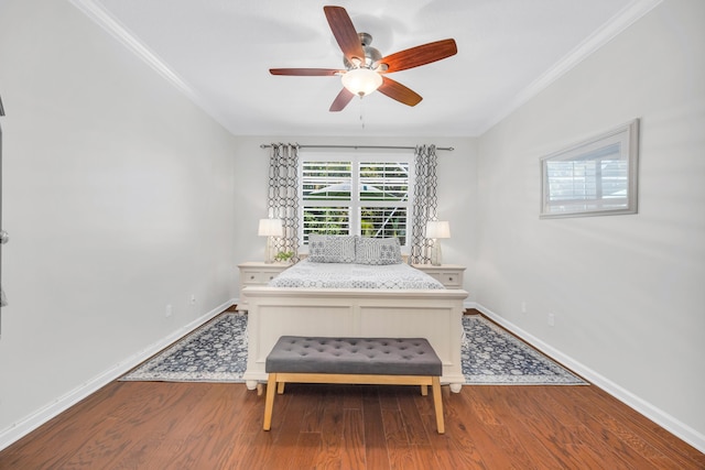 bedroom featuring crown molding, a ceiling fan, baseboards, and wood finished floors