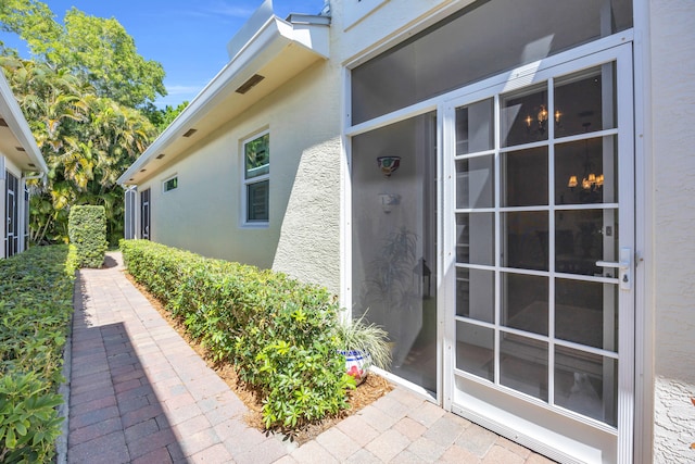 entrance to property with stucco siding