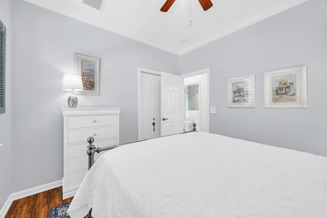 bedroom featuring visible vents, ornamental molding, a closet, baseboards, and dark wood-style floors