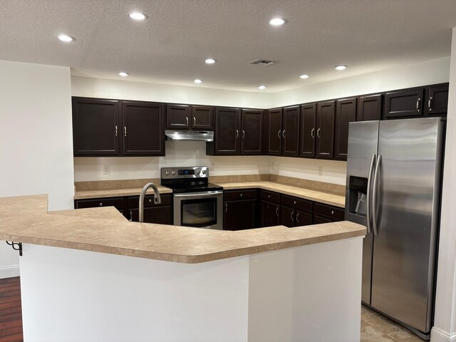 kitchen featuring light countertops, recessed lighting, and appliances with stainless steel finishes