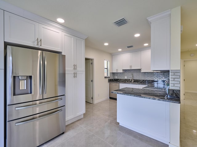 kitchen featuring visible vents, appliances with stainless steel finishes, and white cabinets