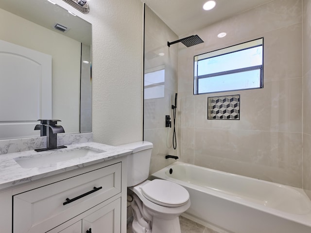 bathroom with visible vents, vanity, toilet, washtub / shower combination, and a textured wall