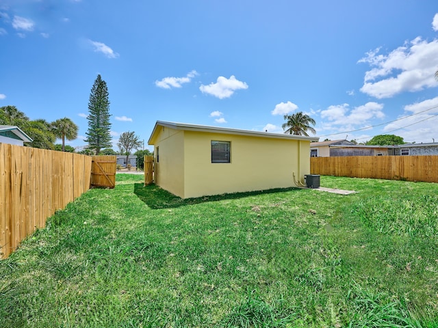 view of yard featuring fence and central air condition unit
