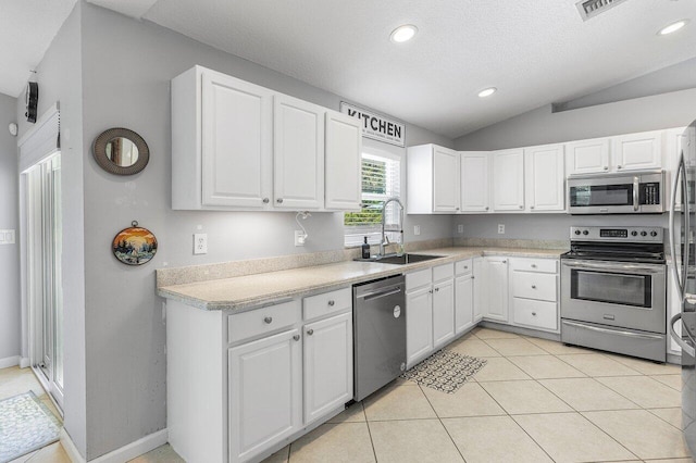 17109 81st Ln N, Loxahatchee, FL 33470 - kitchen featuring white cabinetry, appliances with stainless steel finishes, a sink, and lofted ceiling