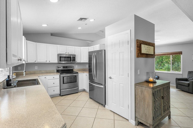 17109 81st Ln N, Loxahatchee, FL 33470 - kitchen with visible vents, light tile patterned flooring, light countertops, a textured ceiling, and appliances with stainless steel finishes