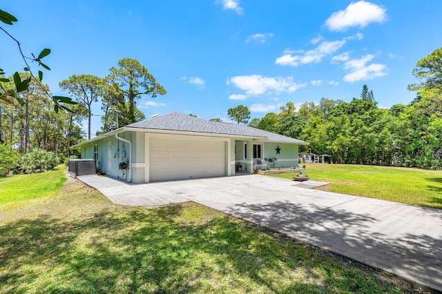 17109 81st Ln N, Loxahatchee, FL 33470 - view of front facade featuring an attached garage, a front lawn, stucco siding, and driveway