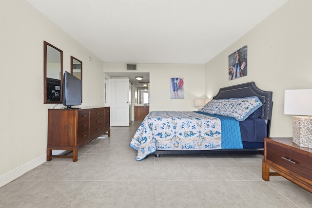 tiled bedroom with baseboards and visible vents