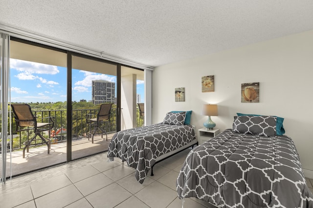tiled bedroom with access to outside and a textured ceiling