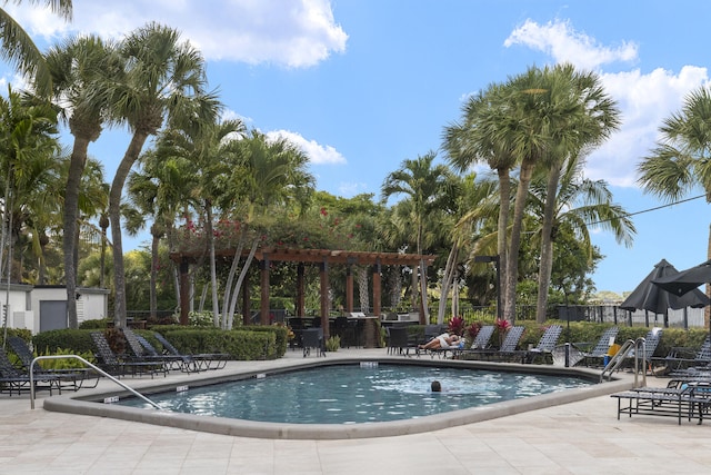 community pool with a patio and fence