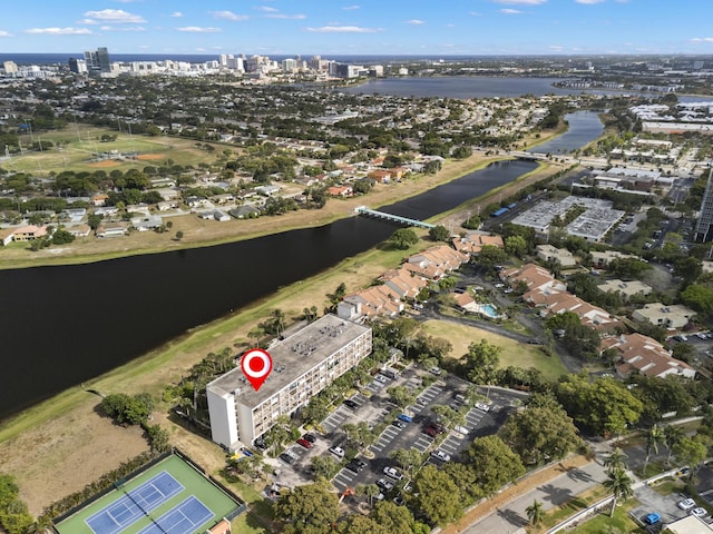 birds eye view of property featuring a city view and a water view
