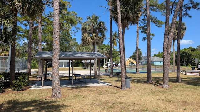 view of property's community featuring a yard, a gazebo, and fence