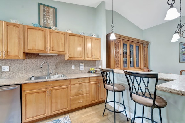 3516 Westminster Dr, Greenacres, FL 33463 - kitchen with dishwasher, a sink, vaulted ceiling, tasteful backsplash, and light wood finished floors
