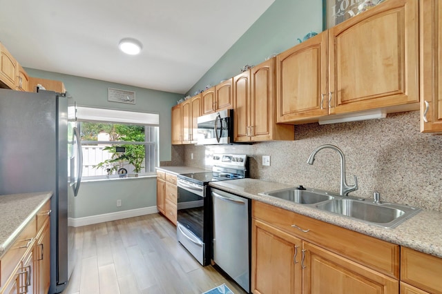 3516 Westminster Dr, Greenacres, FL 33463 - kitchen with appliances with stainless steel finishes, a sink, light countertops, light wood finished floors, and decorative backsplash