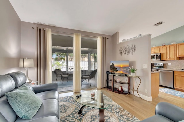 3516 Westminster Dr, Greenacres, FL 33463 - living area featuring vaulted ceiling and light wood finished floors
