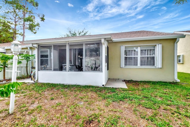 3516 Westminster Dr, Greenacres, FL 33463 - rear view of property featuring a sunroom, stucco siding, and fence