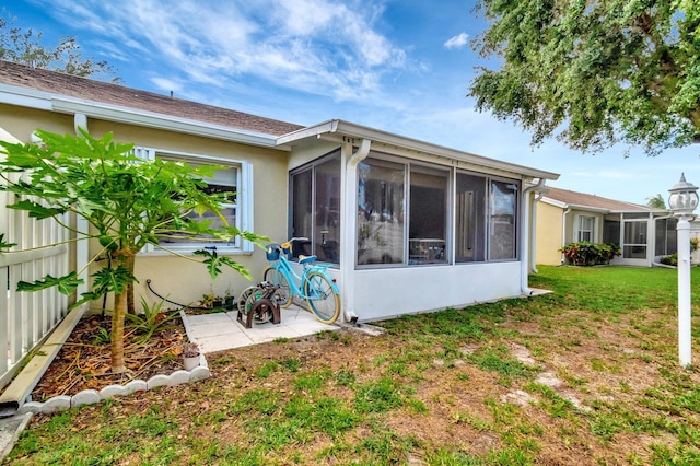 3516 Westminster Dr, Greenacres, FL 33463 - rear view of house featuring a sunroom, stucco siding, and a yard