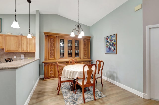 3516 Westminster Dr, Greenacres, FL 33463 - dining area featuring light wood-style flooring, baseboards, a chandelier, and high vaulted ceiling
