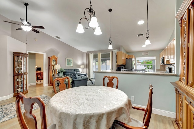 3516 Westminster Dr, Greenacres, FL 33463 - dining space featuring light wood-style flooring, ceiling fan, lofted ceiling, and a chandelier