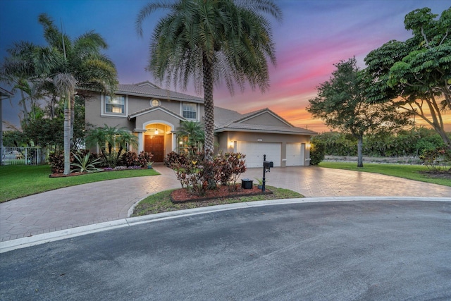 6616 NW 56th Dr, Coral Springs, FL 33067 - view of front of property featuring decorative driveway, stucco siding, and a garage