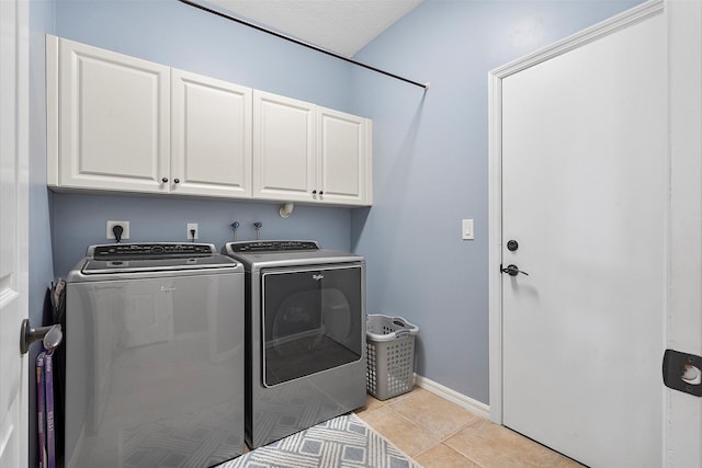6616 NW 56th Dr, Coral Springs, FL 33067 - washroom with cabinet space, independent washer and dryer, light tile patterned floors, and baseboards