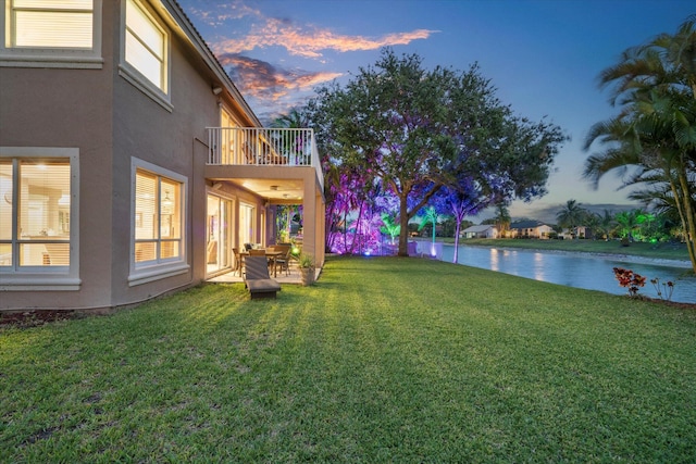 6616 NW 56th Dr, Coral Springs, FL 33067 - yard at dusk featuring a balcony and a lawn