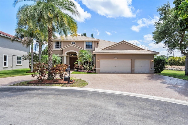 6616 NW 56th Dr, Coral Springs, FL 33067 - mediterranean / spanish-style house featuring stucco siding, decorative driveway, an attached garage, and a tile roof