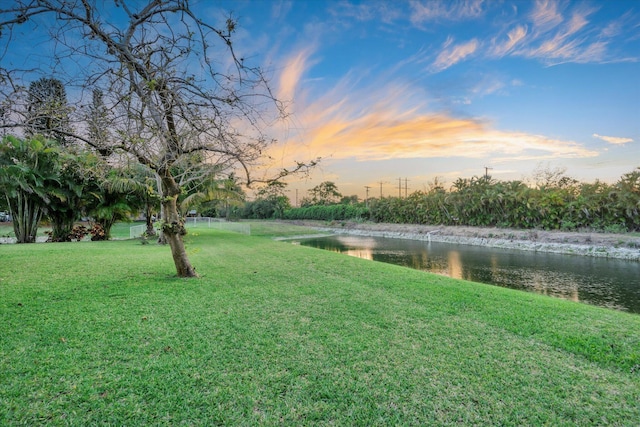 6616 NW 56th Dr, Coral Springs, FL 33067 - view of green lawn featuring a water view