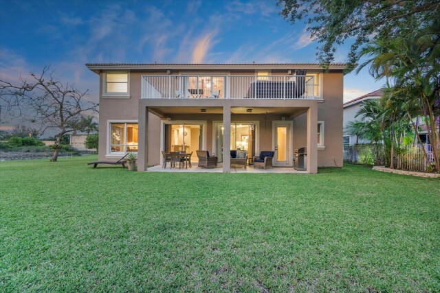 6616 NW 56th Dr, Coral Springs, FL 33067 - back of house featuring a balcony, stucco siding, a patio, and an outdoor hangout area