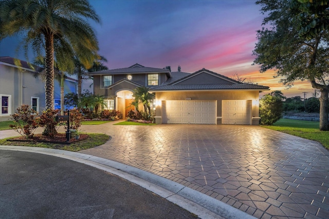 6616 NW 56th Dr, Coral Springs, FL 33067 - view of front facade featuring decorative driveway, stucco siding, and an attached garage