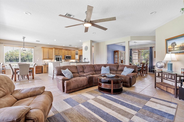 6616 NW 56th Dr, Coral Springs, FL 33067 - living room featuring light tile patterned flooring, a ceiling fan, a textured ceiling, and recessed lighting