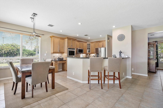 6616 NW 56th Dr, Coral Springs, FL 33067 - dining area with a textured ceiling, recessed lighting, light tile patterned floors, and baseboards