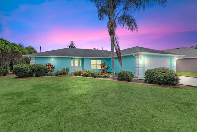 130 SW Airview Ave, Port Saint Lucie, FL 34984 - ranch-style home with an attached garage, a yard, and stucco siding
