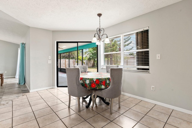 130 SW Airview Ave, Port Saint Lucie, FL 34984 - dining room featuring a chandelier, a textured ceiling, and light tile patterned floors