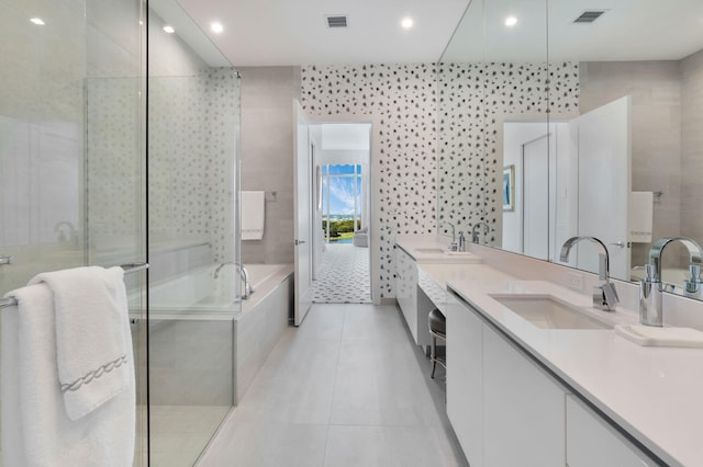 20155 Boca W Dr Unit Phc902, Boca Raton, FL 33434 - bathroom with tile patterned flooring, double vanity, a bath, a stall shower, and recessed lighting