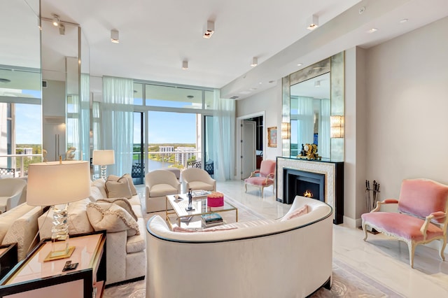 20155 Boca W Dr Unit Phc902, Boca Raton, FL 33434 - living area with floor to ceiling windows, a warm lit fireplace, and light marble finish floors