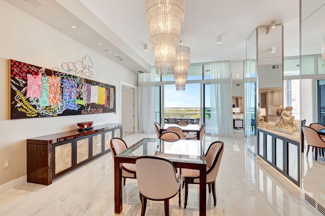 20155 Boca W Dr Unit Phc902, Boca Raton, FL 33434 - dining area with a chandelier, light marble finish floors, a wall of windows, and baseboards