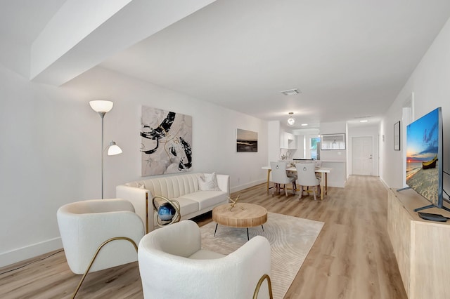 1150 Boxwood Dr Unit 203, Delray Beach, FL 33445 - living room featuring baseboards, light wood-type flooring, and visible vents