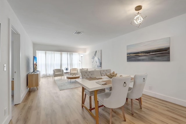 1150 Boxwood Dr Unit 203, Delray Beach, FL 33445 - dining room featuring baseboards, visible vents, and light wood-type flooring