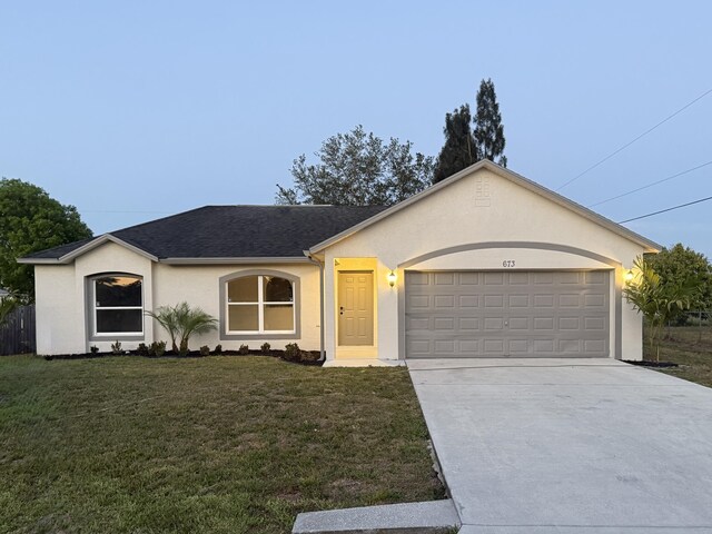 673 SW Granadeer St, Port Saint Lucie, FL 34983 - ranch-style house with an attached garage, concrete driveway, stucco siding, a front yard, and a shingled roof