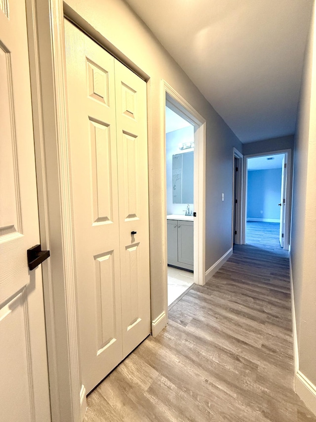 673 SW Granadeer St, Port Saint Lucie, FL 34983 - hall with light wood-style floors and baseboards